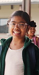 Education, walking and talking with girl child at school for development, future or growth. Conversation, glasses and learning with happy student outdoor at academy for bonding or friendship