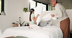 Happy, bedroom and dad with children with pillow fight for bonding, playful and fun on weekend. Family, laugh and boy with girl on bed for games, energy and playing together in home with father