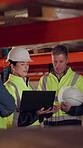 Logistics, team and discussion in warehouse with laptop, quality assurance and advice for operations. Mature people, talk and planning with computer, supply chain update or instructions for shipping.