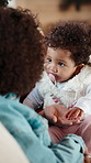 Baby, holding hands and family on sofa in home for bonding, care and love for motor skills in lounge. People, parent and kids with infant, connection and relax on couch with development at apartment