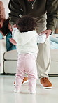 Help, father and baby learning to walk in home with guidance, applause or child development. Family, clapping and dad holding hands with kid for first steps, balance support and proud moment on flare