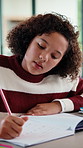 Homework, thinking and child writing in home for activity sheet, education and learning with answer. Student, school and girl with book for assignment, studying and lesson for knowledge development