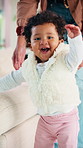 Parent, baby and excited for learning to walk in home with balance, motor skills or child development. Family, happy kid and first steps with teaching mobility, milestone support and healthy growth