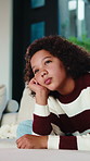 Lonely, child and thinking on couch in home, moody and remember memory on break, thoughts or burnout. Bored, kid and girl with depression on sofa, contemplating and reflection in house and daydream