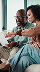 Home, finance and couple with paperwork on sofa for budget planning, bills and mortgage. Marriage, talking and man with woman on tech for expenses, financial payment and online banking for savings