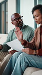 Argue, finance and couple on sofa with documents for bills, mortgage payment and banking. Marriage, frustrated and man and woman with paperwork, conflict and worry for debt, budget or savings mistake