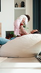 Mom, baby and lift on sofa with play, laugh and bonding in living room with love, care and connection. Mother, child and happy with infant, development or relationship on lounge at family house