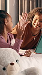 Mom, girl and high five with tablet on bed for bonding, elearning and motivation in home. People, mother and daughter with tech, support or online course on application with love at family house