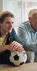 Soccer, watching tv and man with senior father on sofa in home for bonding, esports or online tournament. Laugh, ball and male person with elderly dad for streaming football match together in house.