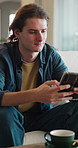 Man, relax and typing in living room with phone, check online dating profile and social media update. Person, chill and scroll in home with tech, internet connectivity or mobile app for text message.