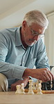 Old man, chess and game in home with strategy, solution or problem solving in contest in living room. Senior person, boardgame and idea with competition for thinking, knowledge or challenge on sofa