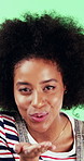 Black woman, smile and blow kiss in studio with face, confidence and afro on green background. African girl, flirting and hand gesture with lips, cosmetics and happy with pout for portrait in Nigeria