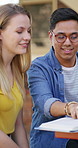 Reading, friends and man with textbook on campus, learning support or explain info for knowledge. Education, college student or people with help for understanding, smile or study for exam preparation