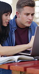 Laptop, college student or team with research on campus, learning support or assignment for knowledge. Education, course essay or happy people with textbook for exam preparation, pc or studying help