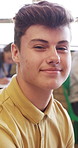 High school, face or boy in classroom with laugh, knowledge or scholarship in academic development. Education, smile or teenager with confidence, student humor or growth in learning opportunity.
