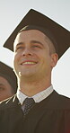 Graduation, thinking and man with group for achievement, ceremony or education success at university. Post grad student, sunshine or outdoor with people for event, academic milestone or qualification