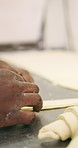 Chef, hands and dough in bakery with croissant preparation, cooking and hospitality in small business. Baker, person and score raw pastry in kitchen with tools, food ingredients and culinary process.
