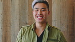 Face, creative or man with laugh by wooden wall, marketing career or campaign development opportunity. Portrait, ads management or Asian person with ambition for branding project, funny or happiness