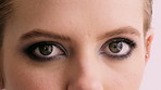 Eyes, eyeshadow and face of woman in studio for beauty, cosmetics and mascara on white background. Cosmetology, portrait and closeup of person with makeup, eyeliner and products for aesthetic