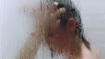 Glass, water drops and woman with haircare in shower for scalp cleansing, wellness and cleaning. Steam, person and washing hair in home for dandruff treatment, personal hygiene and grooming routine