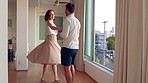 Home, love and couple holding hands for dancing, weekend bonding and connection for relationship. Romantic moment, support and happy people with fun in apartment, spin and moving to music together