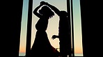 Silhouette, dance and couple by window in hotel for bonding, love and romantic moment at sunset. Marriage, travel and man with woman spin for relationship, holiday and celebrate anniversary at resort