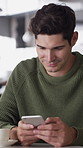 Happy, phone and man with drink in coffee shop for social media, online chat and networking. Laugh, restaurant and person on cellphone for message, text and contact with  internet joke in cafe