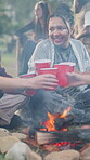 Festival, friends and woman with toast by bonfire, weekend celebration and bonding at social event. Cheers, reunion and happy people with alcohol drinks for summer break, outdoor or gathering for fun