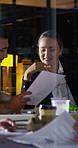 Night, meeting and business people in office with documents, financial report and laptop for audit. Late, team and discussion in firm with finance paperwork, computer or strategy for risk management.