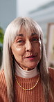 Video call, talking and face of woman in home with communication, advice or gossip in living room. Happy, POV and portrait of mature female person on virtual conversation for contact in apartment.