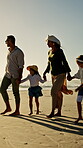 Walking, parents or children holding hands on beach, family holiday or wind for weekend travel trip. Sunset, people and girls with support for summer vacation, sea breeze and smile for bonding 