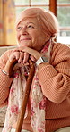 Nostalgia, happy and senior woman with cane for good memory, reflection and wondering. Retirement, nursing home and elderly person on sofa for daydreaming, thinking and remember with walking stick