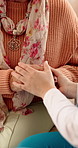 Holding hands, caregiver and senior woman on sofa for comfort, empathy and care in assisted living. Retirement, healthcare and nurse with elderly patient for bonding, relationship and medical support