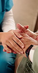Holding hands, home and nurse with elderly person for comfort, empathy and care in assisted living. Retirement, healthcare and caregiver with patient for bonding, relationship and medical support
