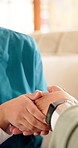 Holding hands, caregiver and senior woman on sofa for comfort, empathy and support in assisted living. Retirement, healthcare and nurse with elderly patient for bonding, relationship and kindness
