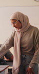 Woman, teacher and talk with students in classroom for exam, assistance and education. Muslim, educator and helping children with test instructions, academic assessment and learning support at school