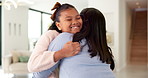 Happy, girl and hug with mom in home for comfort, love and support with affection or care. Child, daughter or smile with mother embrace or cherish for childhood, trust or bonding together in house