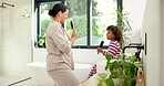 Mother, child and singing with hairbrush in bathroom for grooming, fun morning routine and bonding. Happy, mom and son with haircare tool in home for karaoke, getting ready and dancing with self care