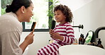 Mother, kid and singing with hairbrush in bathroom for grooming, fun morning routine and bonding. Happy, mom and child with haircare tool in home for karaoke, getting ready and dancing with self care