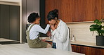 Mom, child and holding hands with kiss in kitchen for comfort, parenthood or love in home. Mother, assurance and affection with child, kid or girl for soothing, support or gentle parenting in house