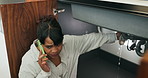 Woman, phone call or pipe with water leak for plumber assistance, repair or sink fix in home. Female person, discussion or concern with smartphone, broken or damaged basin for advice or help in house