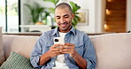 Relax, man and happy with phone on sofa for text message joke, social media post or status update. Weekend, person and laugh with mobile in home for funny comment, browsing and streaming for me time