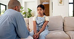 Sad, child and father with lecture on sofa for bad behavior, discipline and agreement to warning. Lesson, dad and reprimand unhappy kid in home for attitude problem, teaching manners or explain rules