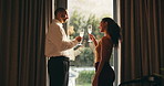 Happy couple, champagne and toast at window in hotel room for celebration, anniversary and bonding. People, partnership and drinks with relationship goals, achievement and glass at luxury resort