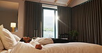 Bed, business and fall with man in hotel room for accommodation, hospitality or travel. Break, relax and resting with corporate employee in bedroom of luxury resort for company or working trip