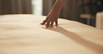 Woman, hand and touch sheets on bed for material quality, fabric texture and interior design in home. Person, duvet inspection and check comfort of mattress with soft linen, cotton or review in house