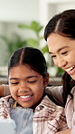Girl, mother and happy with tablet on sofa for games, bonding or laugh with movie choice in family home. Asian people, mom and child with tech, application and smile with online puzzle at house