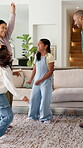 Family, dance and happy children in home for fun, energy and bonding with celebration. Excited, happiness and people or parents with kids for playful rhythm, movement and music in living room