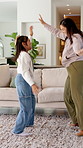 Happy, mom and dancing with child in home for playful bonding, music or vibe together. Excited, mother and kid holding hands with smile or energy for weekend celebration, holiday or party in house
