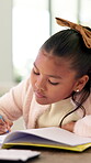 Learning, child or writing on paper in book for math homework, calculation solution or study. Student, kid or numeracy workbook at table for problem solving, division answer or homeschool assessment
